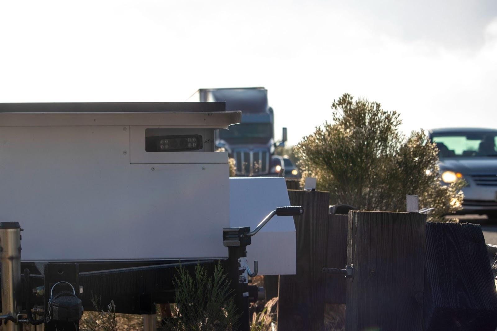 A white box with a black roof
AI-generated content may be incorrect.